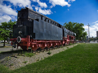 Obraz premium old steam locomotive, which is black and red and stands at the main station in Braunschweig as a museum piece