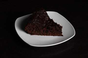 Chocolate Cake Slice on White Plate with Black Background