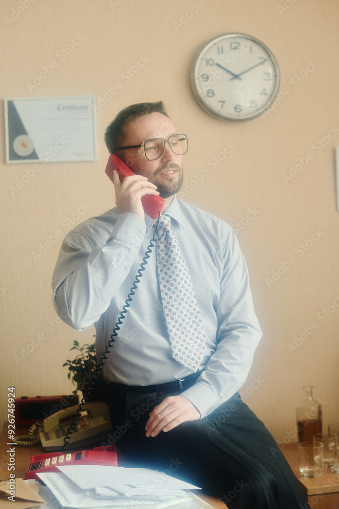 Poster Man in office holding phone to ear with certificate and clock on wall displaying business environment