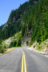 Scenic Stevens Canyon Road at Mount Rainier National Park passing rugged rock cliff