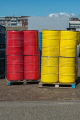 red and yellow oil barrels wrapped in transparent plastic