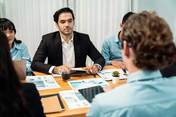 Diverse group of business analyst team analyzing financial data report paper on office table. Chart and graph dashboard by business intelligence analysis for strategic marketing planning Habiliment