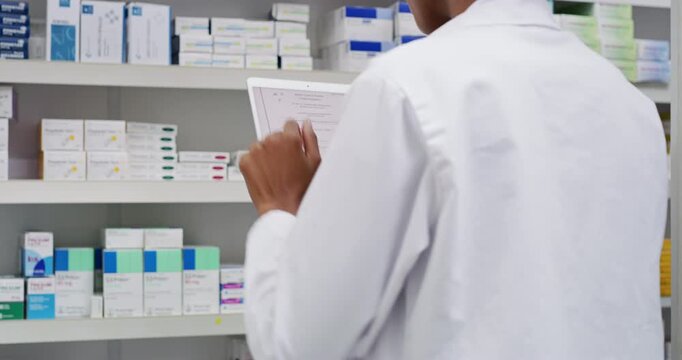 Pharmacist, hands and tablet by shelf of medicine research, stock inventory and planning in ecommerce or healthcare store. Back of pharmacy person or doctor on digital technology, checklist and pills