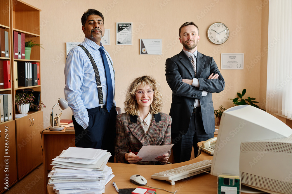 Poster diverse business team in professional office setting with documents, computer, and various office su