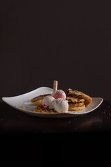 Waffles with Strawberry and Vanilla Ice Cream, Colorful Sprinkles, Waffle Cone, and Chocolate Sauce