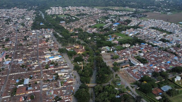 Aerial View of Buga with Guadalajar River Centered, Surrounded by Trees and Urban Houses