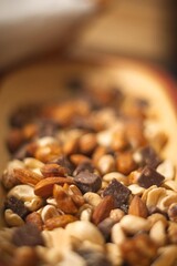 Close-Up of Mixed Seeds, Peanuts, Nuts, and Chocolate in a Wooden Bowl