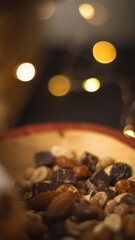 Close-Up of Mixed Seeds, Peanuts, Nuts, and Chocolate in a Wooden Bowl