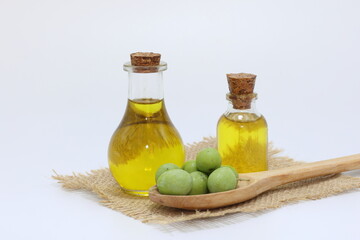 olive oil and green olives on white background