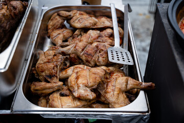 A beautifully arranged tray overflowing with succulent grilled chicken pieces and a spatula beside it, ready to serve a delightful meal. Enjoy the amazing taste that satisfies your hunger