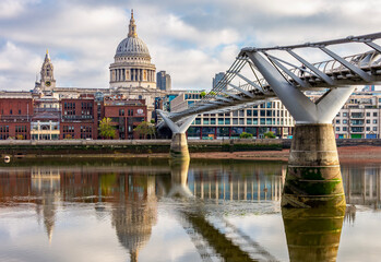 Naklejka premium St. Paul's cathedral and Millennium bridge over Thames river, London, UK