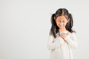 Fototapeta premium Young kid girl pressing on chest pain isolated on white background, painful expression heartache, kindergarten children having heart attack heart disease, Painful cramps problem