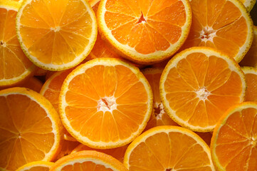 Pattern of slices citrus-fruit of oranges on beige background. Healthy food, diet and detox concept. Flat lay, top view