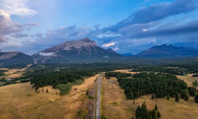 Scenic Road in Mountain Valley, Canadian Countryside. Aerial Sunrise. Alberta, Canada