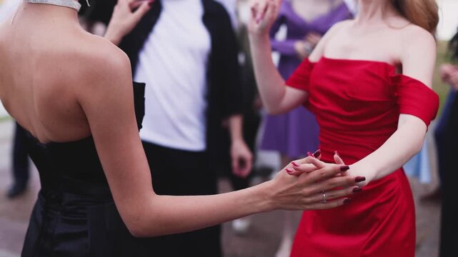 High school graduates dancing on prom, waltz and classical ball dance in dresses and suits on school graduation party, girls and boys classical ballroom dancers, couples dance quadrille and polonaise