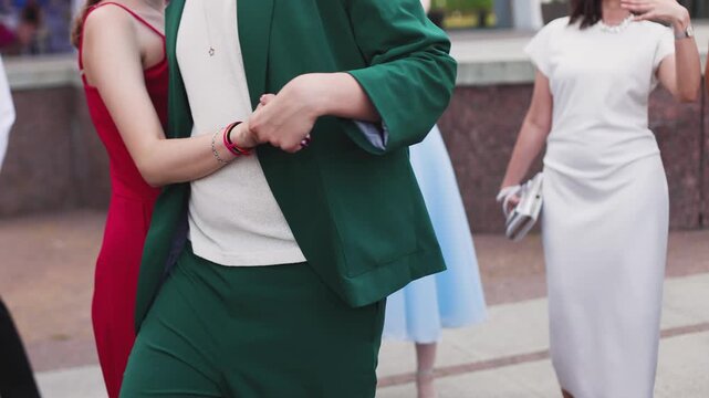 High school graduates dancing on prom, waltz and classical ball dance in dresses and suits on school graduation party, girls and boys classical ballroom dancers, couples dance quadrille and polonaise