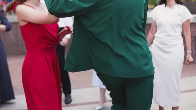 High school graduates dancing on prom, waltz and classical ball dance in dresses and suits on school graduation party, girls and boys classical ballroom dancers, couples dance quadrille and polonaise