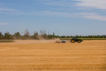 agricultural work in the field. Tractor harvests