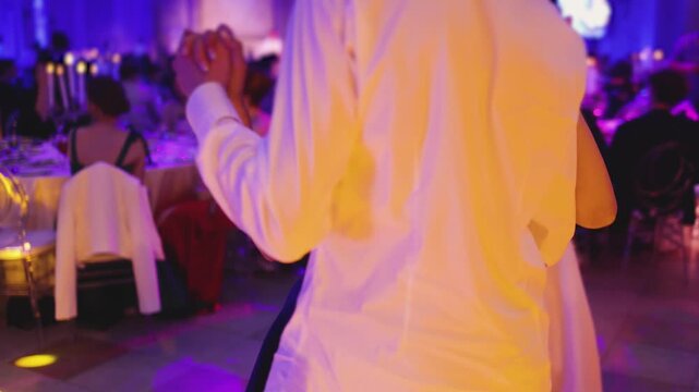 High school graduates dancing on prom, waltz and classical ball dance in dresses and suits on school graduation party, girls and boys classical ballroom dancers, couples dance quadrille and polonaise