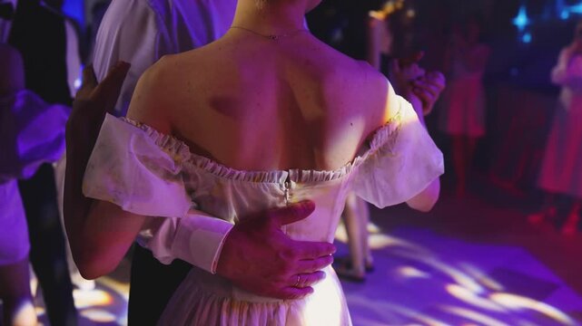 High school graduates dancing on prom, waltz and classical ball dance in dresses and suits on school graduation party, girls and boys classical ballroom dancers, couples dance quadrille and polonaise