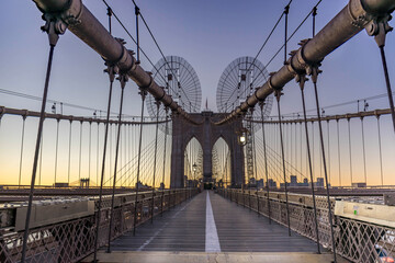 Fototapeta premium Brooklyn Bridge over East River viewed from New York City Lower Manhattan waterfront at sunset