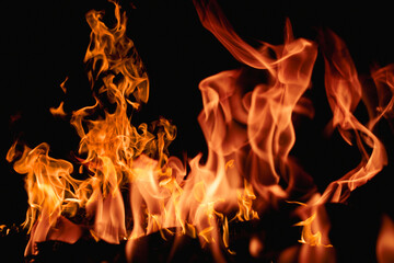 Fire over black background. Fire sparks background. Abstract blaze flames background. Burning fire. Texture of fire on a black background.