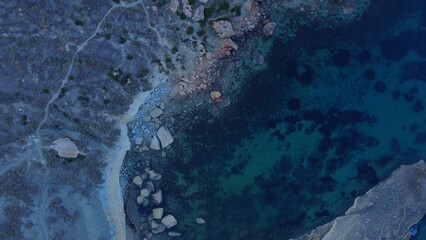 Rocky beach and sapphire sea water on the Maltese island, mediterranean sea, Ghajn Tuffieha bay , Malta. High quality photo