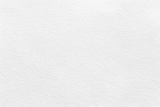 Close-up of seamless white watercolor paper texture background with subtle, natural patterns and a smooth finish. Ideal for creative projects requiring clean, artistic paper surfaces.