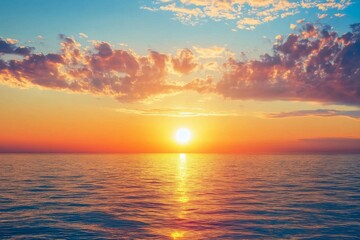 Obraz premium Serene summer sunset over the sea with golden sunlight reflecting on the water and soft clouds in the sky, creating a peaceful and tranquil atmosphere.