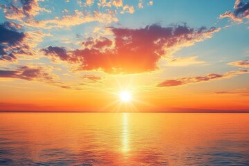 Fototapeta premium Serene summer sunset over the sea with golden sunlight reflecting on the water and soft clouds in the sky, creating a peaceful and tranquil atmosphere.