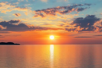 Obraz premium Serene summer sunset over the sea with golden sunlight reflecting on the water and soft clouds in the sky, creating a peaceful and tranquil atmosphere.