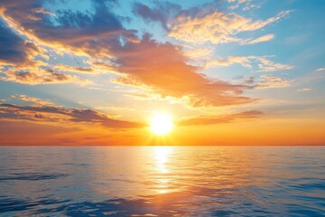 Obraz premium Serene summer sunset over the sea with golden sunlight reflecting on the water and soft clouds in the sky, creating a peaceful and tranquil atmosphere.