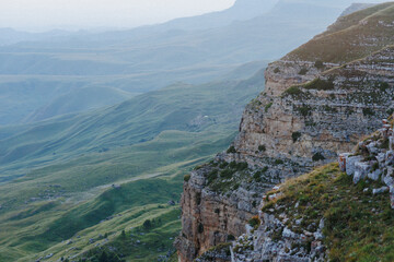 This is a breathtaking view of a sprawling mountain valley observed from the height of a steep...