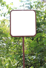 sign is outside with tree in the background