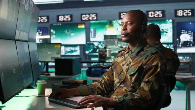 Army specialist working in war room operating surveillance tech, evaluating target data, talking in voice call. Dispatcher keeping in touch with allied troops engaging enemy forces, camera B