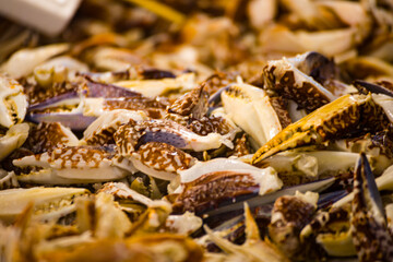 an abundance of stacked fresh crab legs, varying in color from white to brown