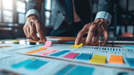 Fototapeta premium Businessman working on a strategy with colorful sticky notes