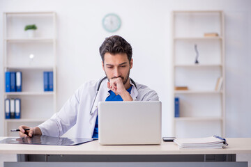 Young male doctor radiologist working in the clinic