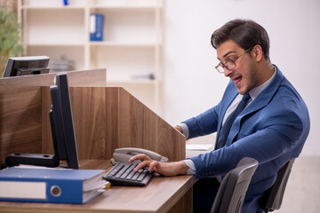 Young male employee working in the office