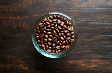 Coffee beans in glass on a dark wooden background