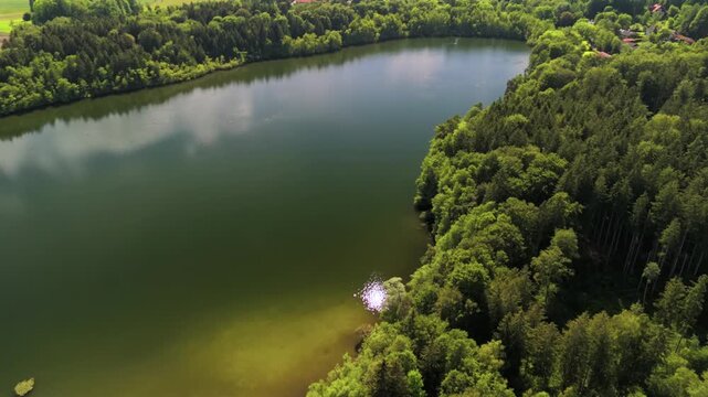 Steinsee bei Munchen Luftaufnahme. Steinsee, See in Bayern Luftbildansicht. Lake Stein aerial view near Munich, Bavaria, Germany. One of warmest lakes in Germany. Steinsee is located in forest area. 