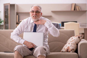 Old male employee working from home during pandemic