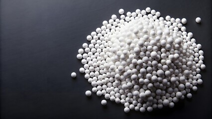 Urea fertilizer balls on black background, top view, urea, fertilizer, carbamide, nitrogen, white, mineral, granules