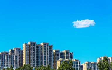 Beautiful high-rise residential building, set against a blue sky background