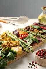 Delicious grilled vegetables with spices on white table
