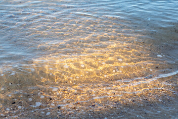 Sunlit wave on the sandy shore. Coochiemudlo Island, Queensland, Australia