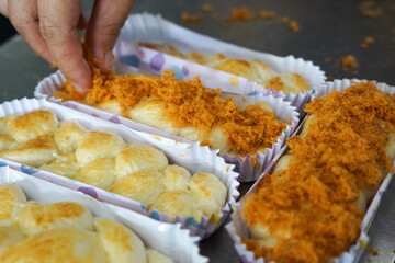 The making of chicken floss bun or bread. Close up.