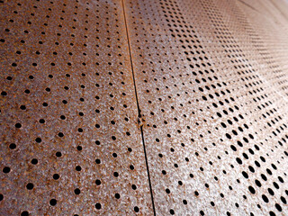 Grunge metal background or texture with holes, scratches and cracks.