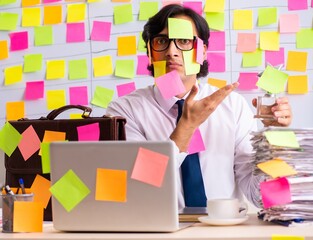 Young employee in conflicting priorities concept