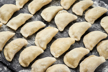 Freshly prepared homemade dumplings ready for cooking, showcasing traditional culinary skills